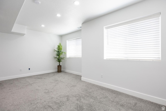 unfurnished room featuring carpet floors, recessed lighting, baseboards, and a smoke detector