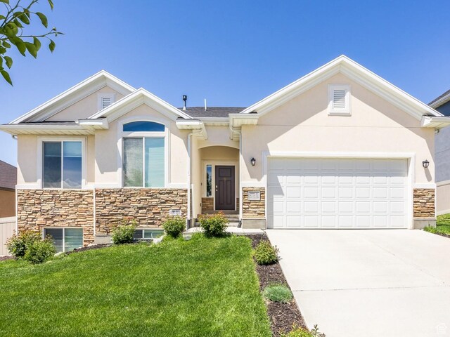 3773 N 750 W, Lehi, UT 84043 - view of front of home featuring stone siding, stucco siding, driveway, a front lawn, and a garage