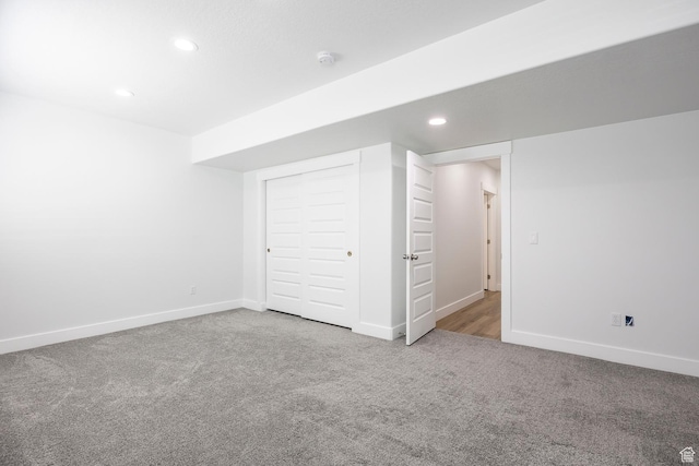 below grade area with carpet floors, recessed lighting, and baseboards
