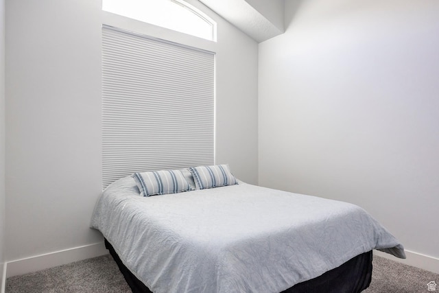 carpeted bedroom featuring baseboards