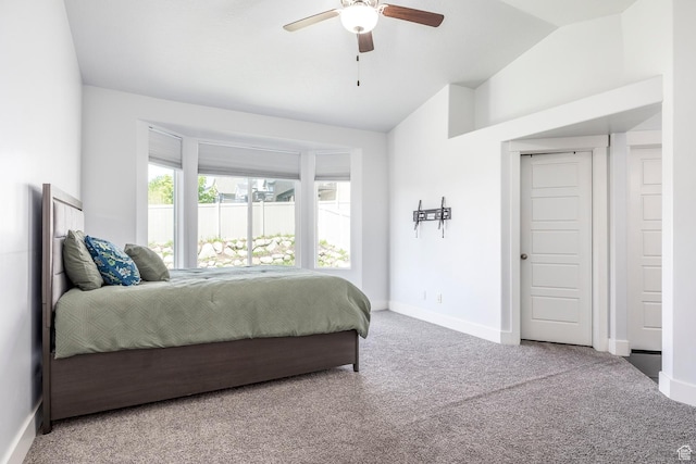 bedroom with carpet flooring, lofted ceiling, baseboards, and a ceiling fan