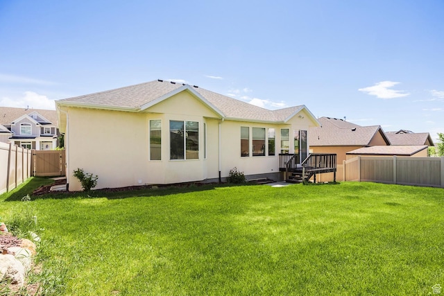rear view of house featuring stucco siding
