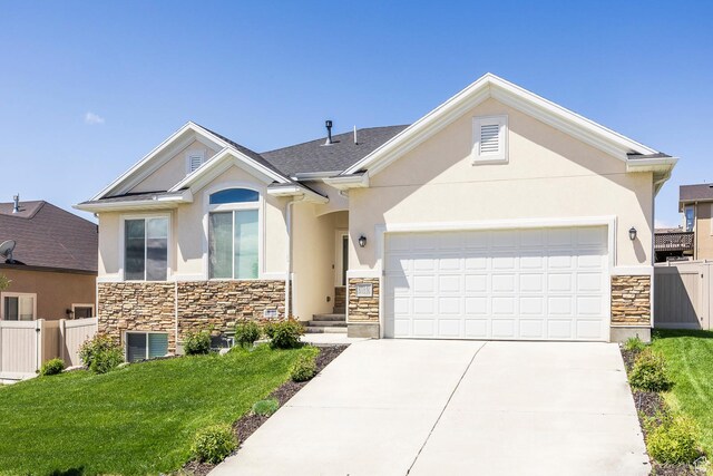 view of front of home featuring stone siding, stucco siding, an attached garage, and driveway