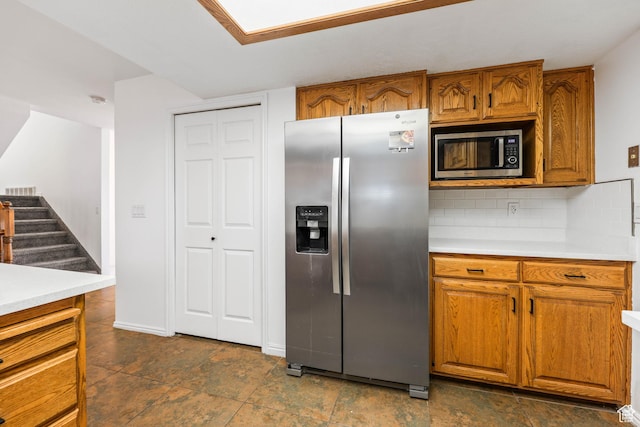 1888 W 1520 N, Clinton, UT 84015 - kitchen featuring stainless steel appliances, brown cabinetry, light countertops, and decorative backsplash