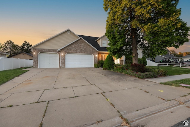 1888 W 1520 N, Clinton, UT 84015 - view of front facade featuring a garage, concrete driveway, and brick siding