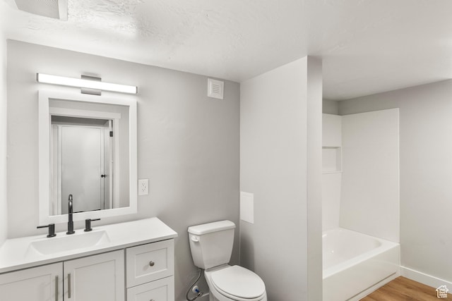 5857 S 2625 W, Roy, UT 84067 - bathroom with toilet, wood finished floors, vanity, baseboards, and a textured ceiling
