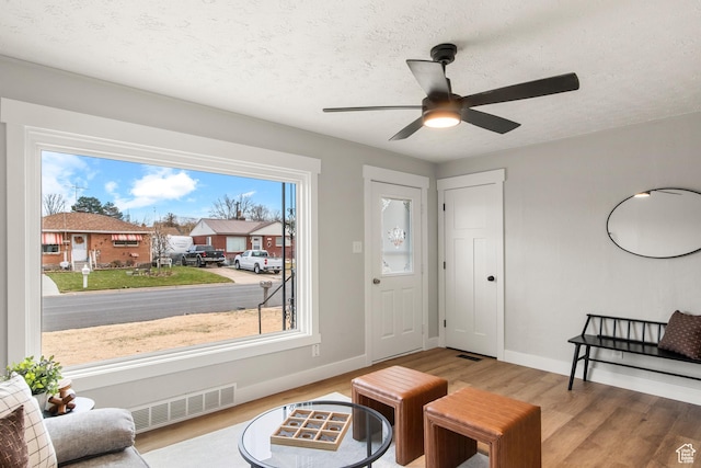 5857 S 2625 W, Roy, UT 84067 - living area featuring wood finished floors, baseboards, ceiling fan, and a textured ceiling