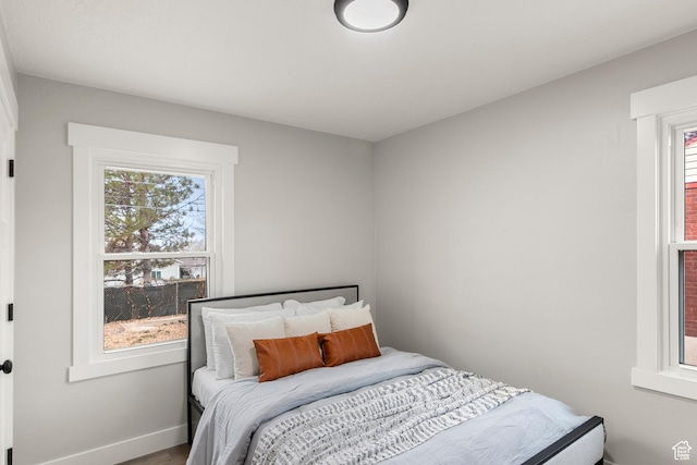 5857 S 2625 W, Roy, UT 84067 - bedroom featuring multiple windows, baseboards, and wood finished floors