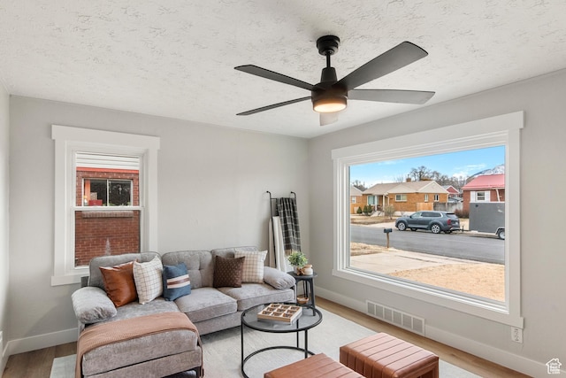 5857 S 2625 W, Roy, UT 84067 - living room with light wood finished floors, baseboards, ceiling fan, and a textured ceiling