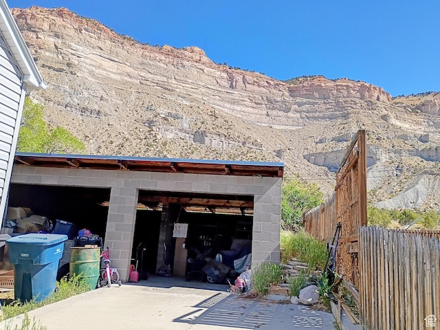 garage with a mountain view and fence