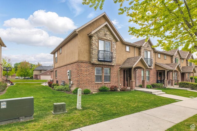 783 W 175 S, Springville, UT 84663 - view of front facade with a balcony, a front yard, stone siding, stucco siding, and a residential view