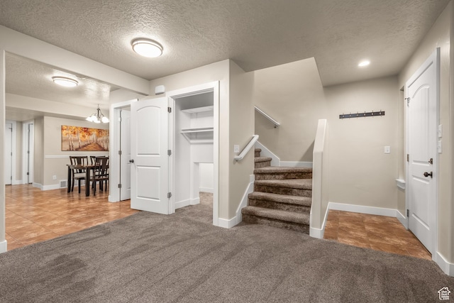 783 W 175 S, Springville, UT 84663 - tiled entryway with a textured ceiling, baseboards, stairs, a chandelier, and carpet