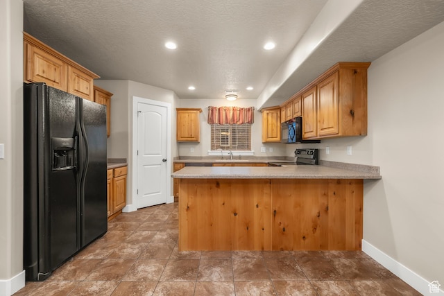 783 W 175 S, Springville, UT 84663 - kitchen with black appliances, a peninsula, baseboards, light countertops, and a sink
