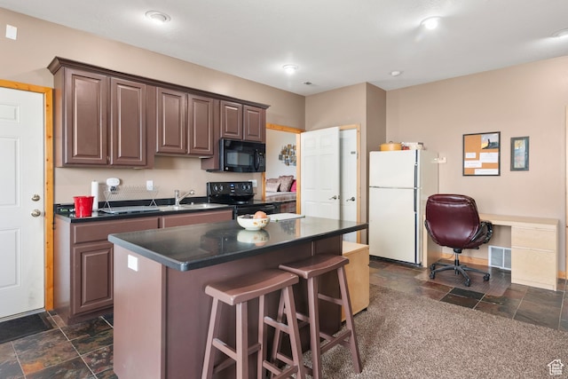 2456 E Bonneville Ter, South Ogden, UT 84403 - kitchen featuring black appliances, stone tile flooring, dark countertops, a kitchen breakfast bar, and a kitchen island