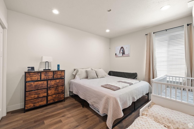 bedroom with wood finished floors, recessed lighting, and baseboards