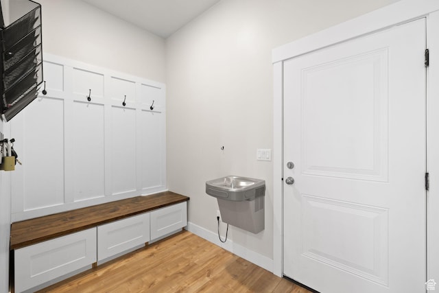 mudroom featuring light wood-style flooring and baseboards