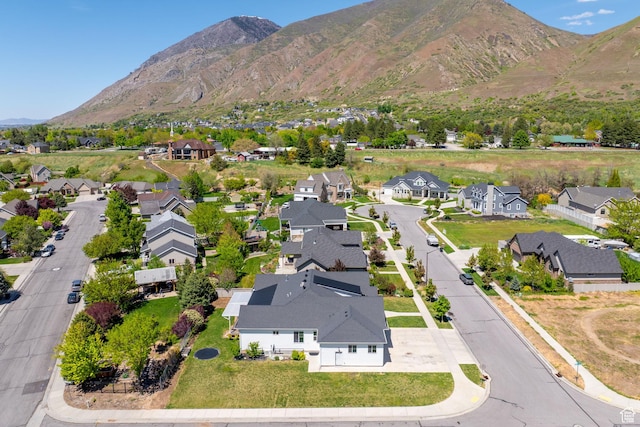 aerial view of property and surrounding area featuring nearby suburban area and mountains