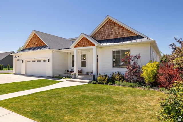 craftsman-style house featuring a standing seam roof, concrete driveway, a front lawn, an attached garage, and metal roof