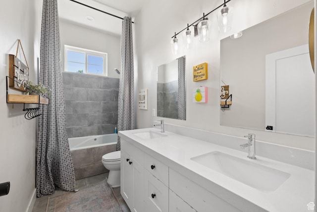 bathroom with toilet, tiled shower / bath combo, tile patterned flooring, and double vanity