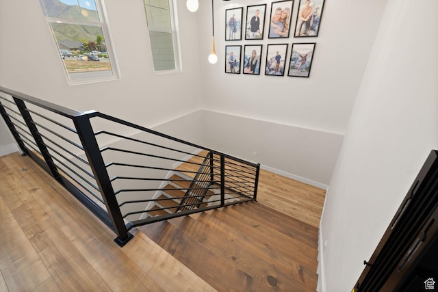 stairs featuring wood finished floors and baseboards