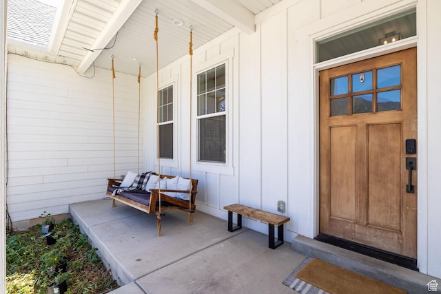 entrance to property featuring covered porch and board and batten siding