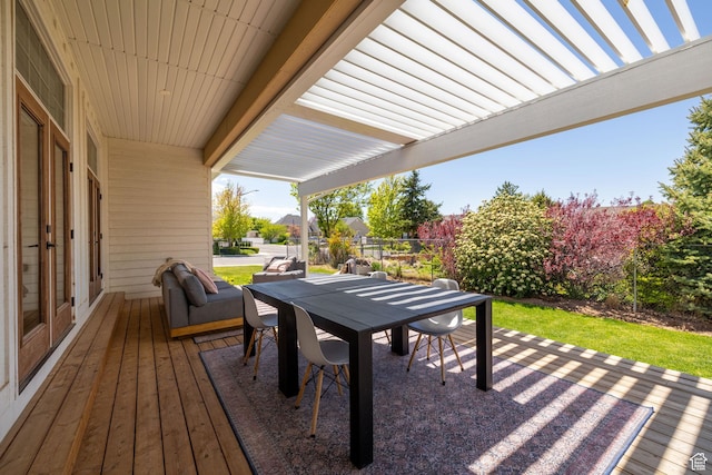 deck featuring outdoor dining space, fence, and a patio area