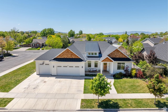 craftsman-style house featuring a garage, a standing seam roof, driveway, a residential view, and a front yard