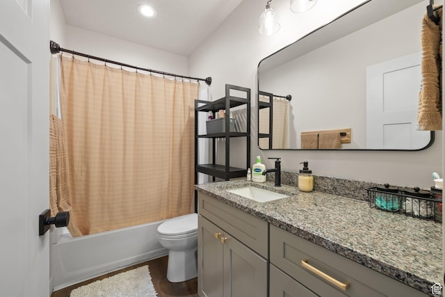 full bathroom with wood finished floors, toilet, vanity, shower / bath combo, and recessed lighting