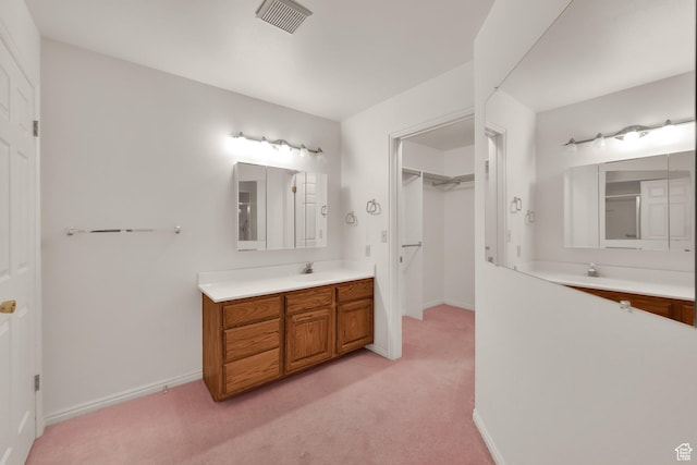 full bathroom with vanity, baseboards, and carpet flooring