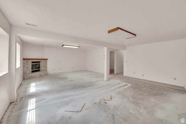 unfurnished living room featuring a brick fireplace