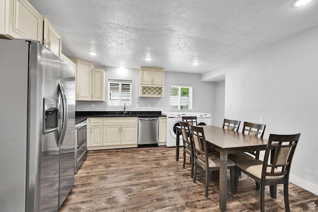 256 13th St, Ogden, UT 84404 - kitchen featuring appliances with stainless steel finishes, washer / clothes dryer, a sink, dark wood-style floors, and a textured ceiling