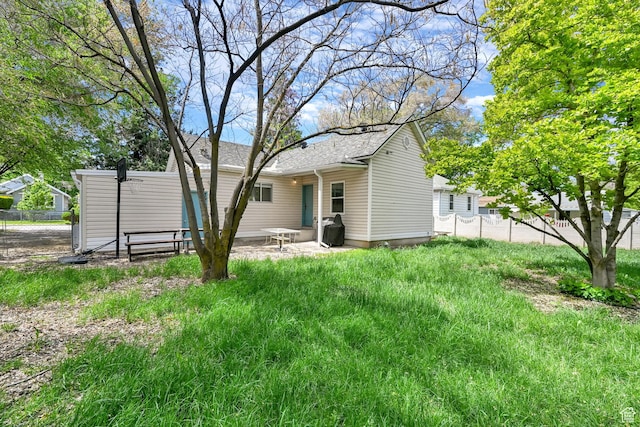 256 13th St, Ogden, UT 84404 - back of property with fence and a patio area