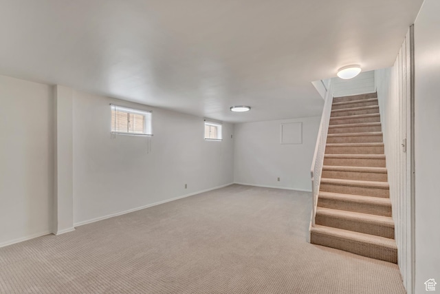3400 S 2000 E, Millcreek, UT 84109 - below grade area featuring light colored carpet, stairway, and baseboards