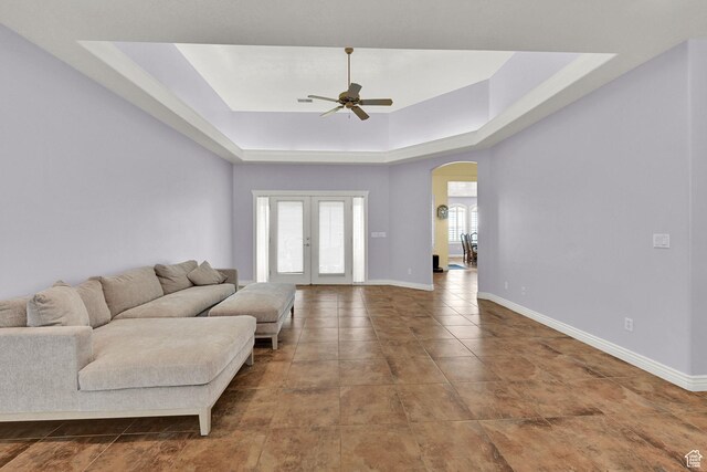 337 S 300 E, Willard, UT 84340 - tiled living room with arched walkways, ceiling fan, a raised ceiling, baseboards, and french doors