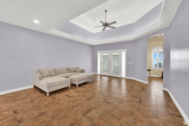 337 S 300 E, Willard, UT 84340 - living room featuring arched walkways, ceiling fan, a raised ceiling, baseboards, and tile patterned flooring