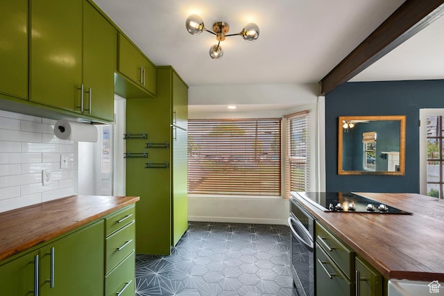 kitchen featuring butcher block counters, oven, green cabinets, black electric cooktop, and beam ceiling