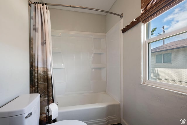 bathroom featuring toilet and shower / bath combo