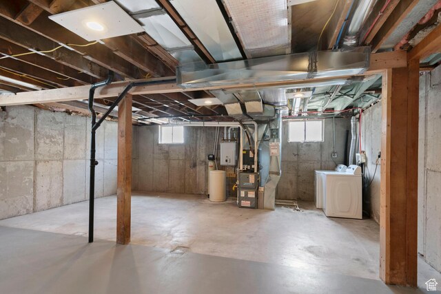 basement with heating unit and separate washer and dryer