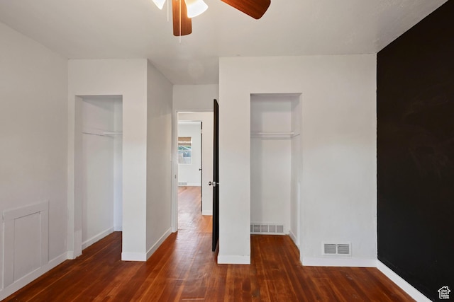 unfurnished bedroom featuring wood finished floors, baseboards, and ceiling fan