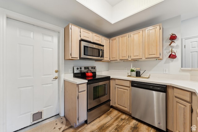 900 Bitner Rd Unit D11, Park City, UT 84098 - kitchen featuring stainless steel appliances, light wood finished floors, light countertops, and light brown cabinets