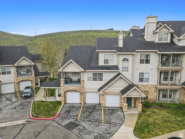 900 Bitner Rd Unit D11, Park City, UT 84098 - townhome / multi-family property featuring a balcony, stone siding, driveway, and an attached garage