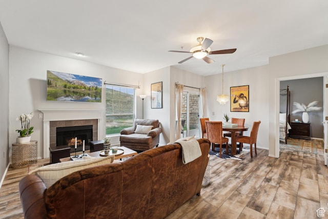900 Bitner Rd Unit D11, Park City, UT 84098 - living area with wood finished floors, ceiling fan, a tile fireplace, and baseboards