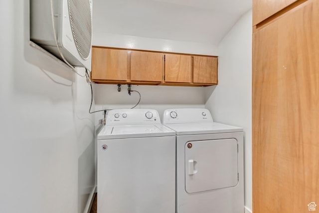 washroom with cabinet space and washing machine and clothes dryer