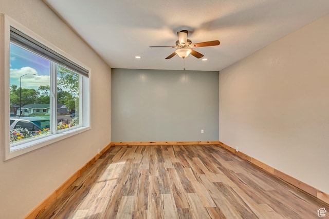 empty room with a ceiling fan, light wood-style floors, baseboards, and recessed lighting