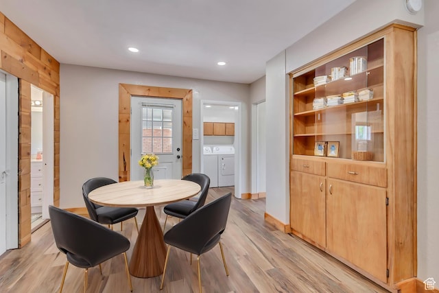 dining room featuring light wood-style flooring, washing machine and dryer, and recessed lighting