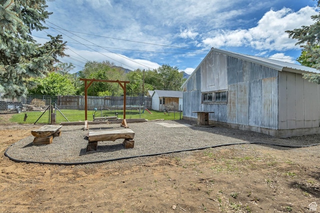 view of yard featuring fence and an outdoor structure