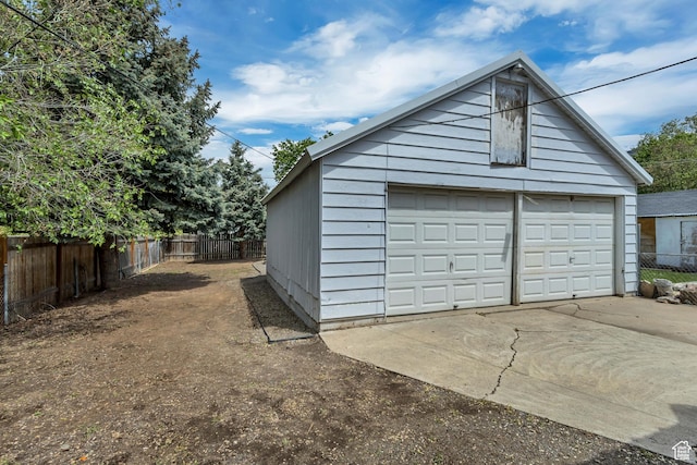 detached garage featuring fence