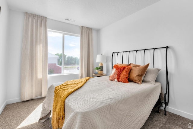 carpeted bedroom featuring baseboards