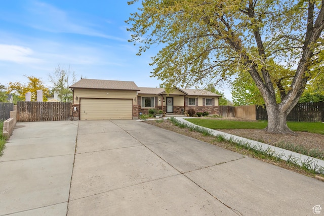 single story home featuring an attached garage, driveway, fence, and brick siding