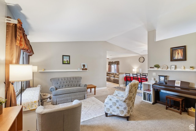 carpeted living area with vaulted ceiling